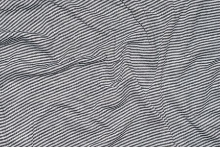 creased white fabric with gray stripes.の写真素材