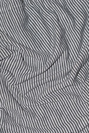 creased white fabric with gray stripes.の写真素材