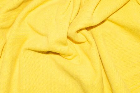 creased yellow material texture or background.の写真素材