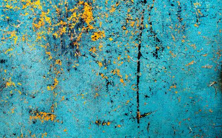 old yellow and blue cracked paint on the wall