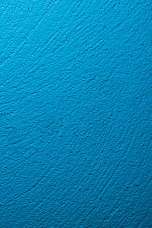 wall painted in blue with visible plaster textureの写真素材