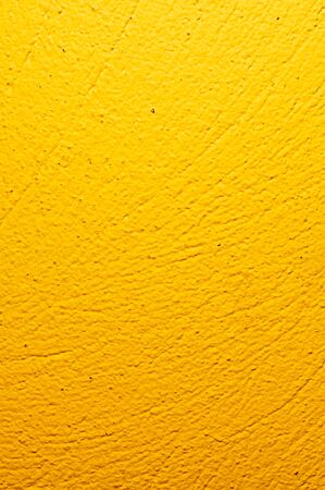 wall painted yellow with visible plaster textureの写真素材