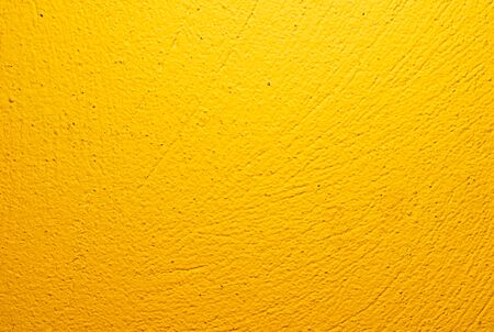 wall painted yellow with visible plaster textureの写真素材