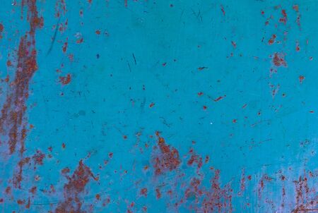old sheet painted blue and visible rustの写真素材