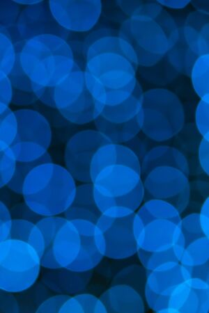 Abstract blue bokeh texture on black backgroundの写真素材