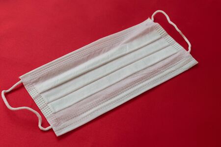 medical mask on a red background. protection against virusesの写真素材