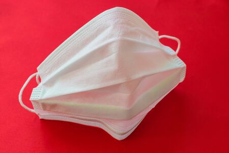 medical mask on a red background. protection against virusesの写真素材