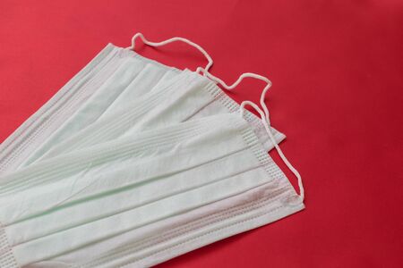 medical mask on a red background. protection against virusesの写真素材