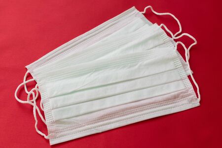 medical mask on a red background. protection against virusesの写真素材