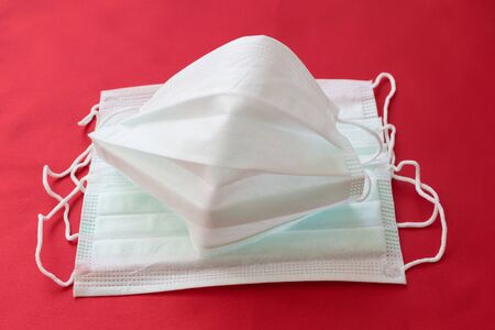 medical mask on a red background. protection against virusesの写真素材