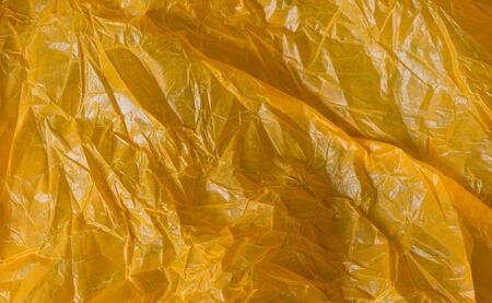 orange wrinkled foil bag. texture or backgroundの写真素材