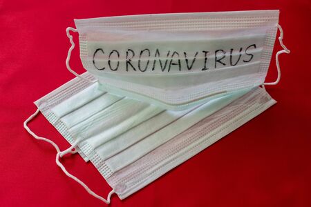 Medical mask with the inscription Coronavirus on a red backgroundの写真素材