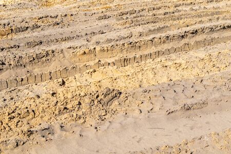 vehicle tracks on yellow sand. Texture or backgroundの写真素材