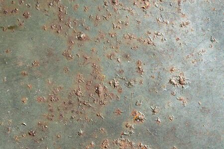 rusting old metal plate painted with green paintの写真素材