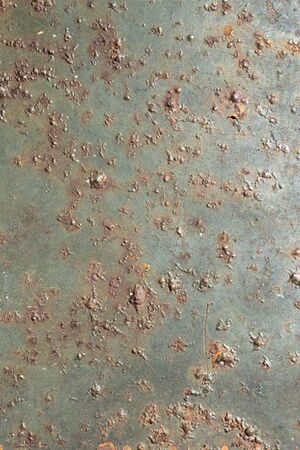 rusting old metal plate painted with green paintの写真素材