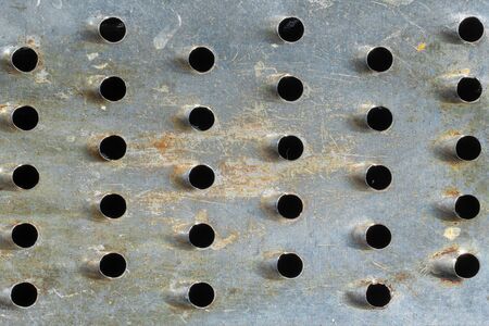 Close-up of metal with holes. texture or backgroundの写真素材