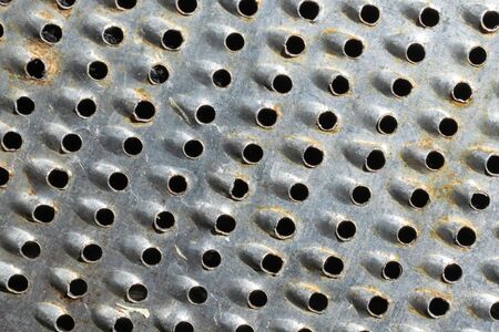Close-up of metal with holes. texture or backgroundの写真素材