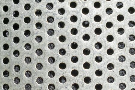 Close-up of metal with holes. texture or backgroundの写真素材