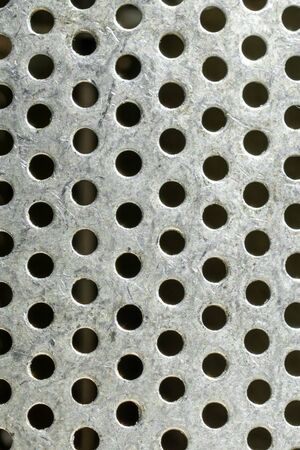 Close-up of metal with holes. texture or backgroundの写真素材