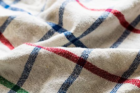 folded creased multicolored checkered woolen fabric backgroundの写真素材