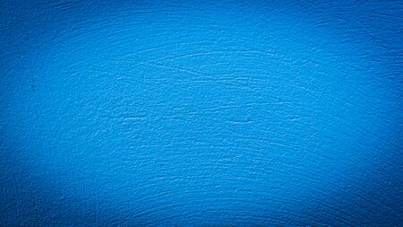 wall painted in blue with visible plaster textureの写真素材