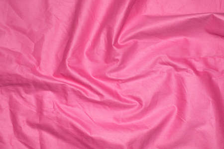 crinkled pink material texture or background.の写真素材