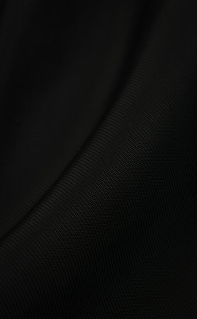 black crinkled material with visible details. backgroundの写真素材