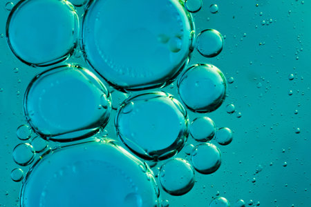 oil drops on water on blue background