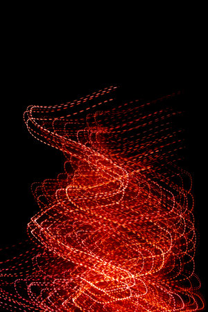 red dotted lines of lights on a black backgroundの写真素材