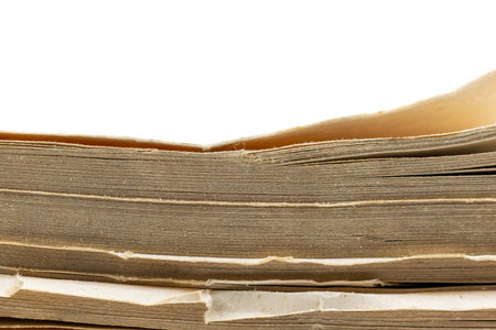 dirty yellowed page from an old book on a white backgroundの写真素材
