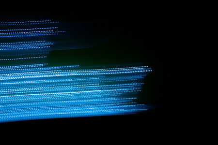 blue dashed lines of lights on a black backgroundの写真素材