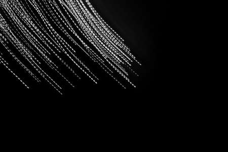 white dashed lines of lights on a black backgroundの写真素材