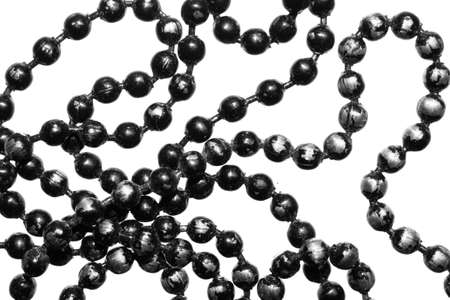 silver beads painted with black paint on a white isolated backgroundの写真素材