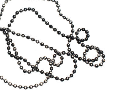 silver beads painted with black paint on a white isolated backgroundの写真素材