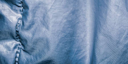 blue crinkled fabric with visible details. backgroundの写真素材