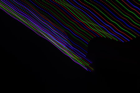 colored lines on a black background.texturaの写真素材