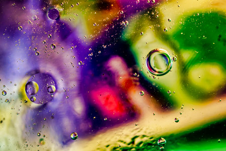 oil drops on water on a multicolored backgroundの写真素材