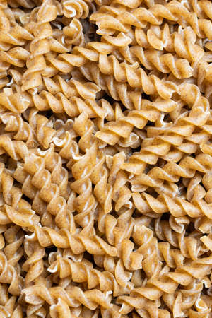 wholemeal pasta with visible details. background or texturaの写真素材