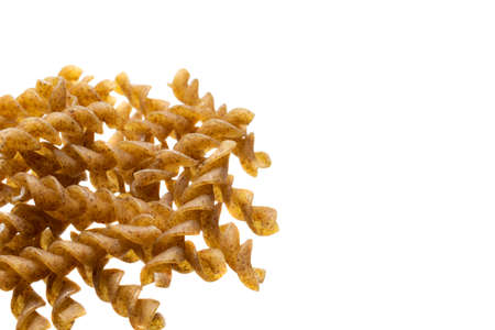 wholemeal pasta on a white isolated backgroundの写真素材