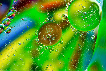 oil drops on water on a multicolored backgroundの写真素材