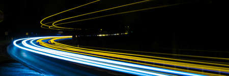 abstract blue and yellow car lights at nightの写真素材