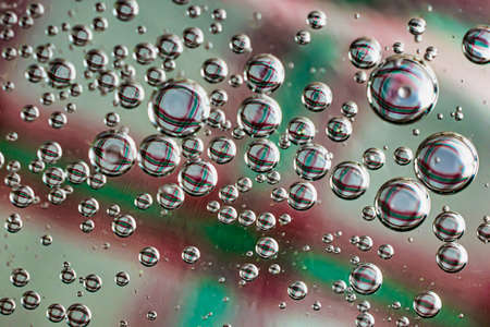 oil drops on water on a multicolored backgroundの写真素材