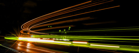 abstract blue and yellow car lights at nightの写真素材