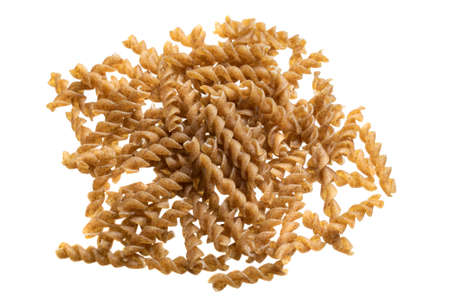 wholemeal pasta on a white isolated backgroundの写真素材