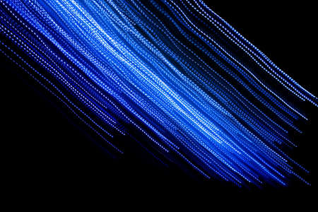 blue dashed lines of lights on a black backgroundの写真素材