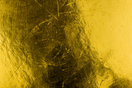 a sheet of paper painted with gold paint. background or textureの写真素材