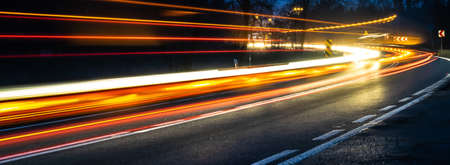 orange and blue car lights at nightの写真素材