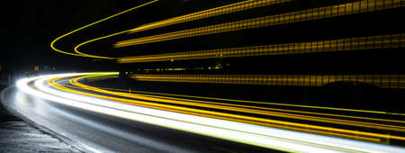 orange and blue car lights at nightの写真素材