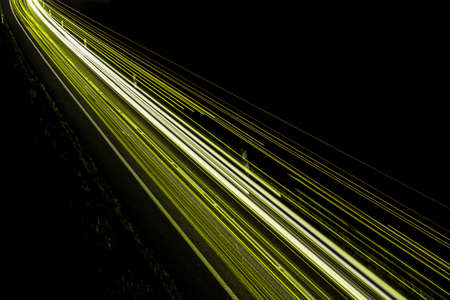 yellow car lights at night. long exposureの写真素材