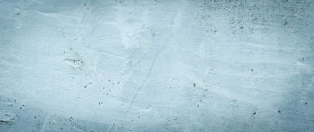a wall with a visible plaster texture painted blue